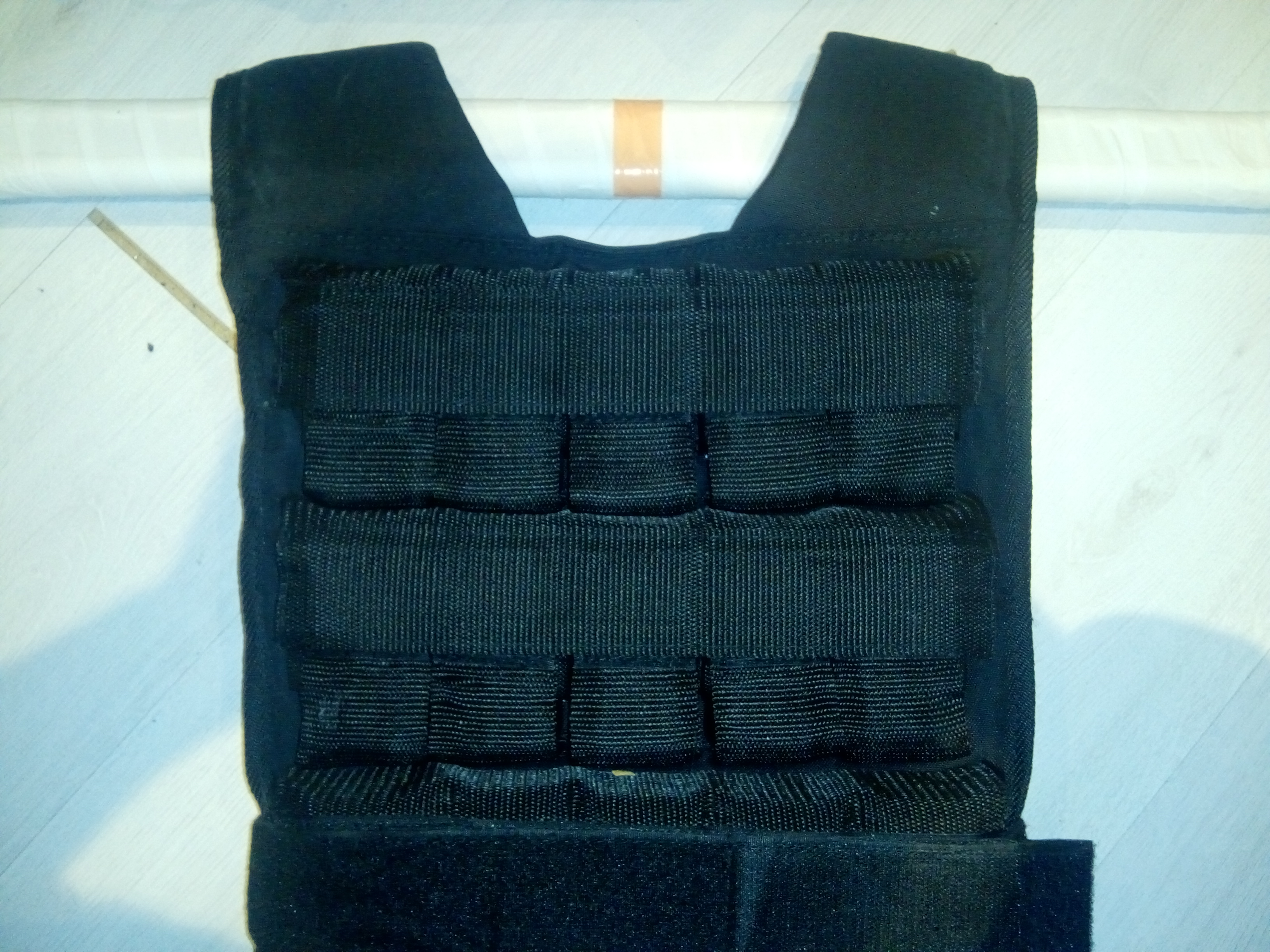 Lifting bar thread through the weighted vest